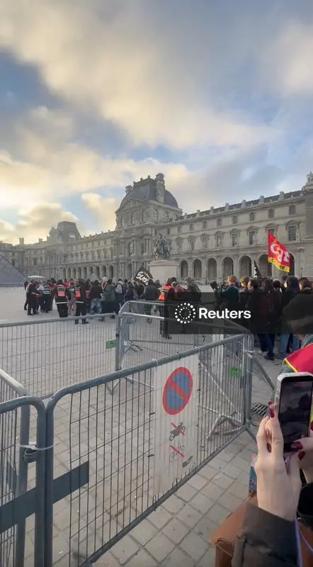 Protesters and students from art and culture schools block the entrance to the Louvre Museum in Paris